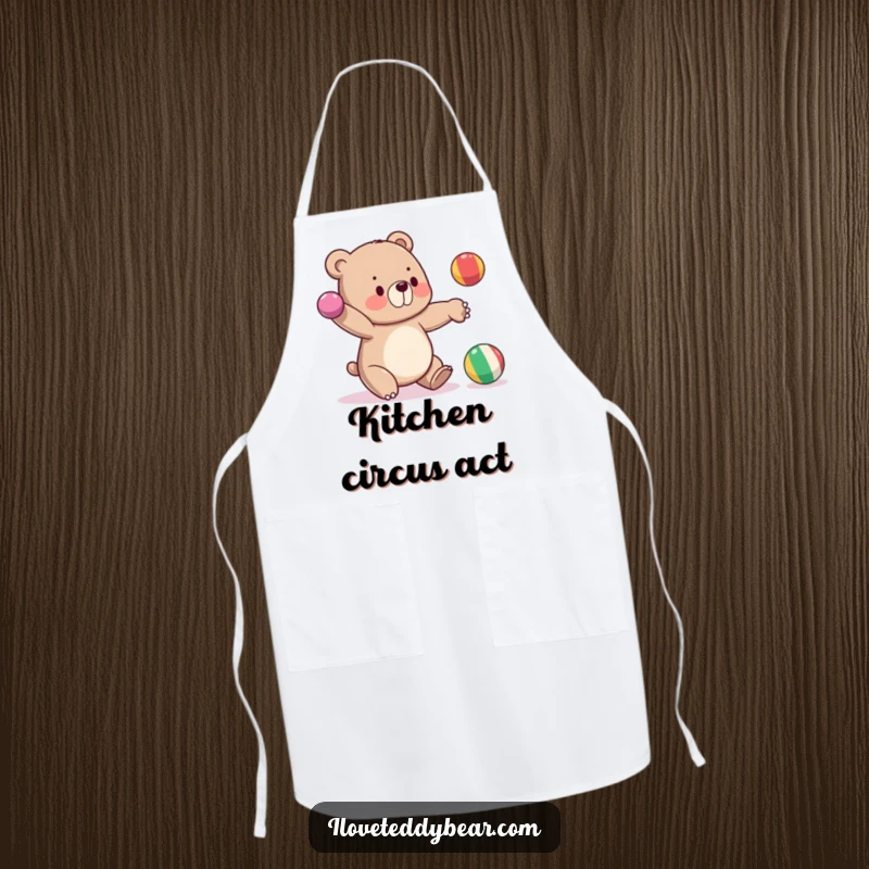 Funny apron with a bear attempting to juggle three balls, one falling, adding humor to kitchen activities.