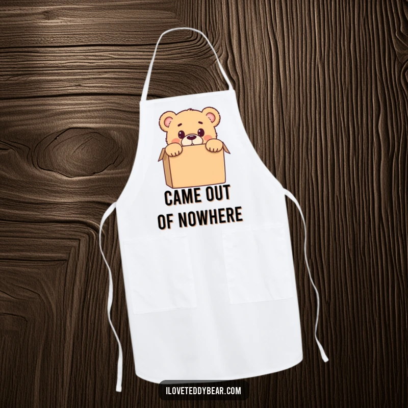 Funny apron with a teddy bear peeking from behind a box, with a surprised expression, ideal for kitchen use and gifting.
