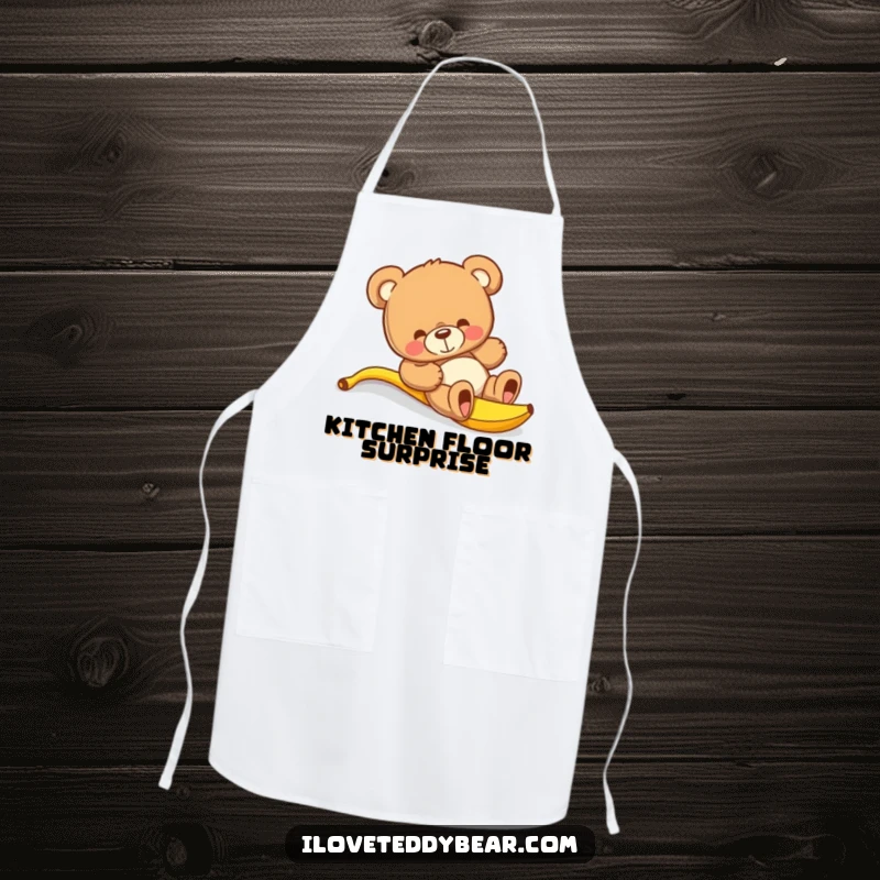 Funny teddy bear apron showing a bear comically slipping on a banana peel while cooking, a hilarious kitchen mishap.