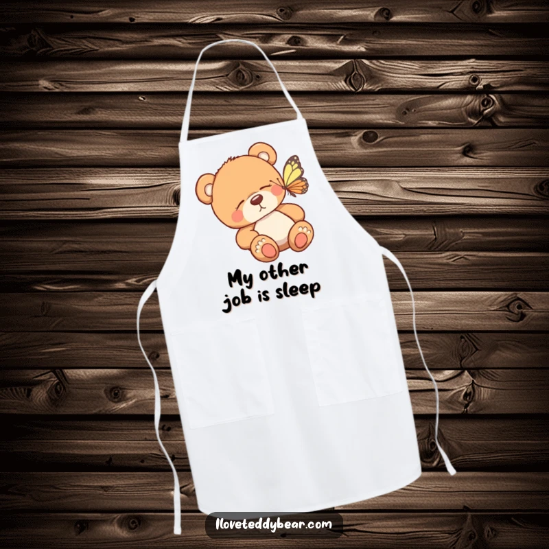 Funny kitchen apron showcasing a sleepy teddy bear being awakened by a colorful butterfly, ideal for adding humor to cooking activities.