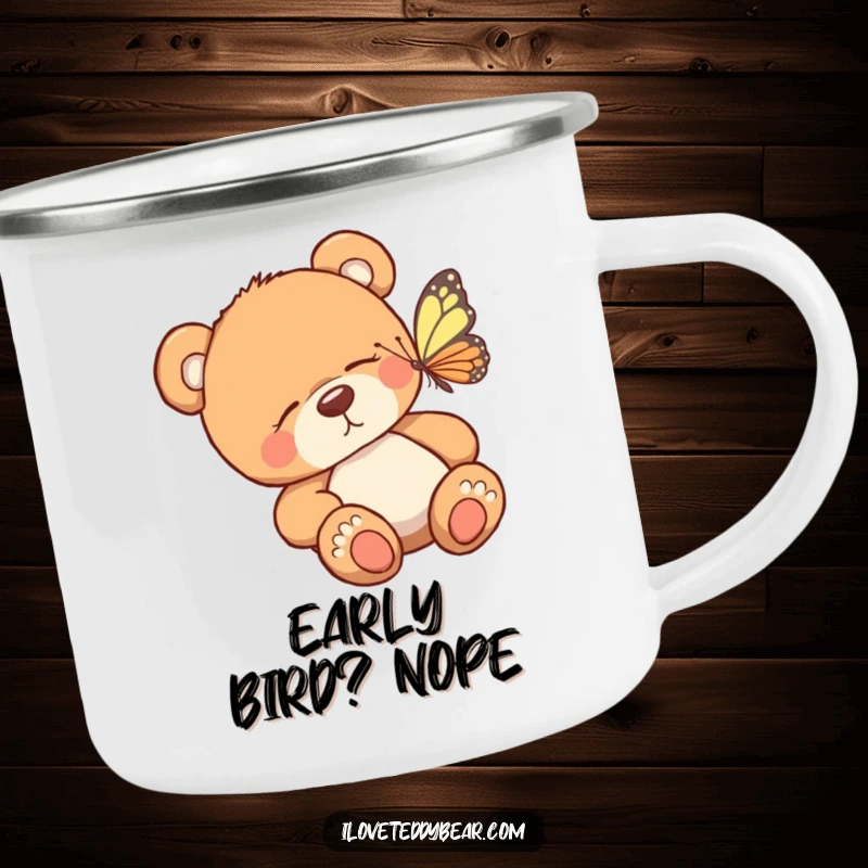 Funny camping mug showing a sleepy teddy bear waking to a fluttering butterfly, perfect for hot beverages in the great outdoors.