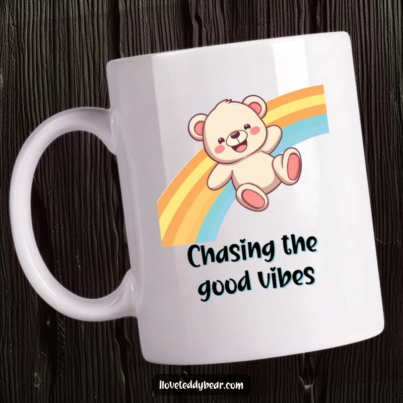 Funny Teddy Bear Mug showing a happy bear sliding down a vibrant rainbow with a wide, joyful grin.