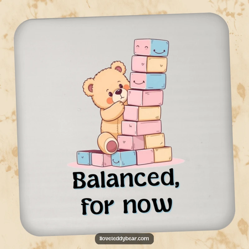 Funny teddy bear coaster featuring a bear precariously building a block tower, protecting surfaces with humor.