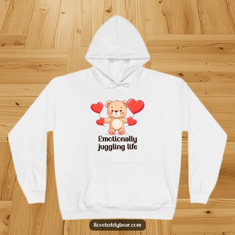 Funny Teddy Bear Hoodie showing a cuddly bear comically attempting to juggle three big red hearts, perfect for warmth and laughter.