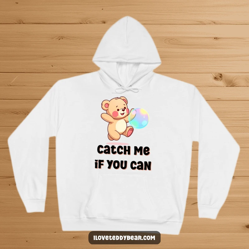 Funny Teddy Bear Hoodie: Cute teddy bear leaping with joy, chasing a large, iridescent bubble with a determined smile.