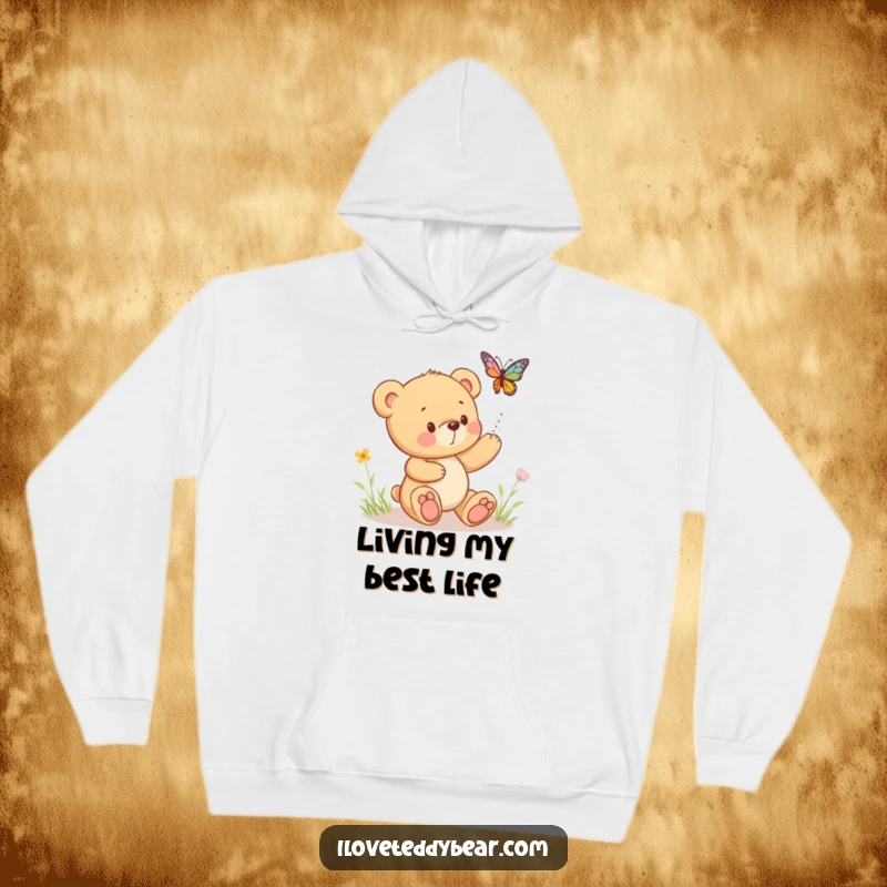 Funny hoodie featuring a teddy bear playfully chasing a bouncing butterfly, offering warmth and a dose of sweet nostalgia.