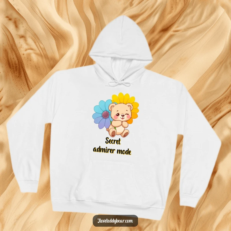 Funny hoodie featuring a teddy bear winking mischievously and hiding a giant flower, offering warmth with a design full of playful secrets.
