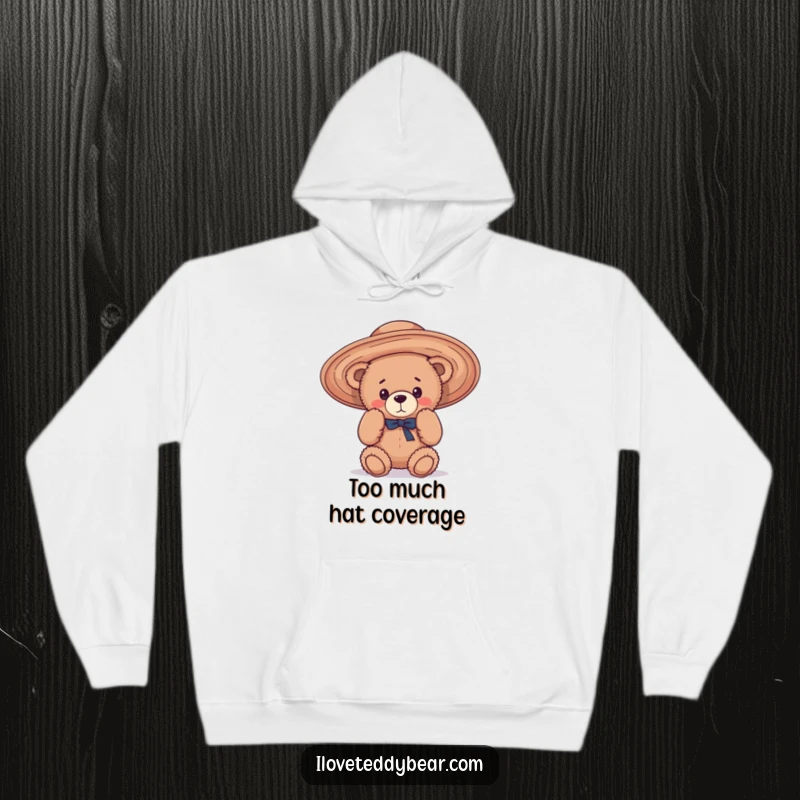 Funny Hoodie illustration of a teddy bear hilariously trying on an oversized, floppy hat, conveying a sense of playful confusion.
