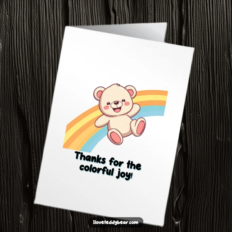 Funny Free Printable Thank You Card: A teddy bear with a huge smile slides down a colorful rainbow, expressing thanks.