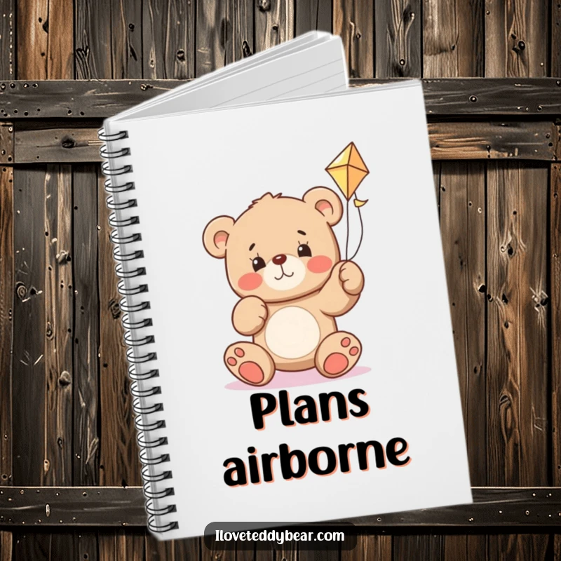 Funny teddy bear notebook with a bear determined to fly a kite, inspiring humorous goal-setting and note-taking.
