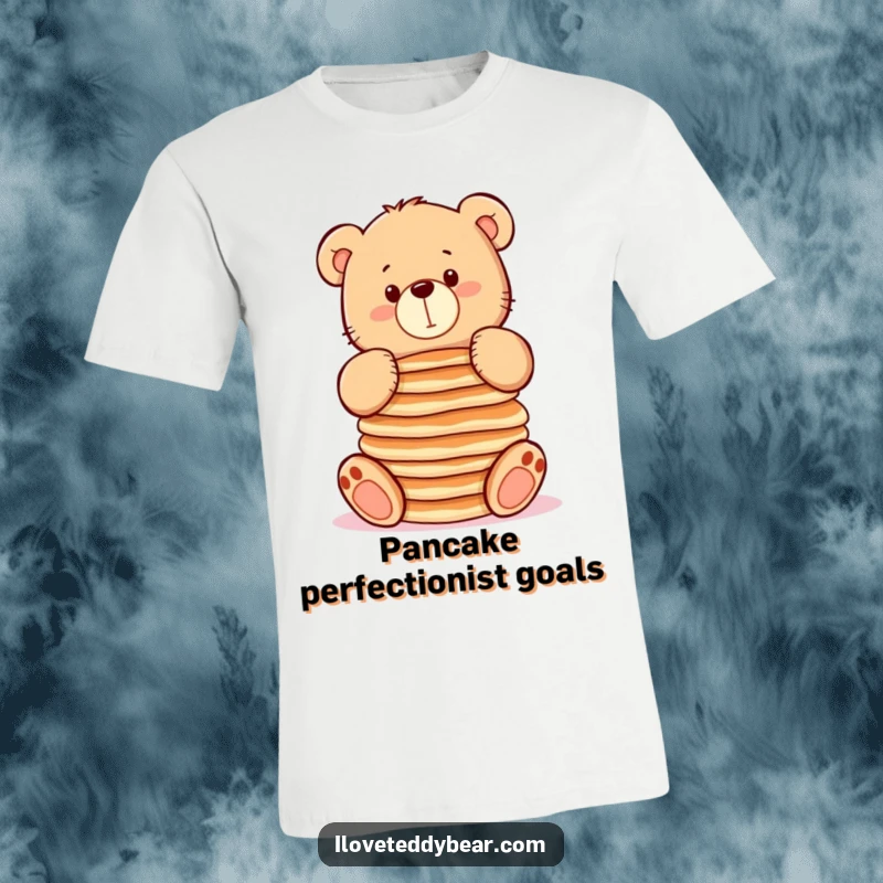 Funny t-shirt depicting a chubby teddy bear attempting to balance a stack of pancakes, great for breakfast lovers and gifts.