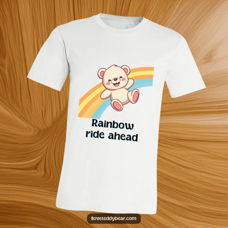 Funny Teddy Bear T-Shirt with a grinning bear joyfully sliding down a colorful rainbow, embodying pure fun.