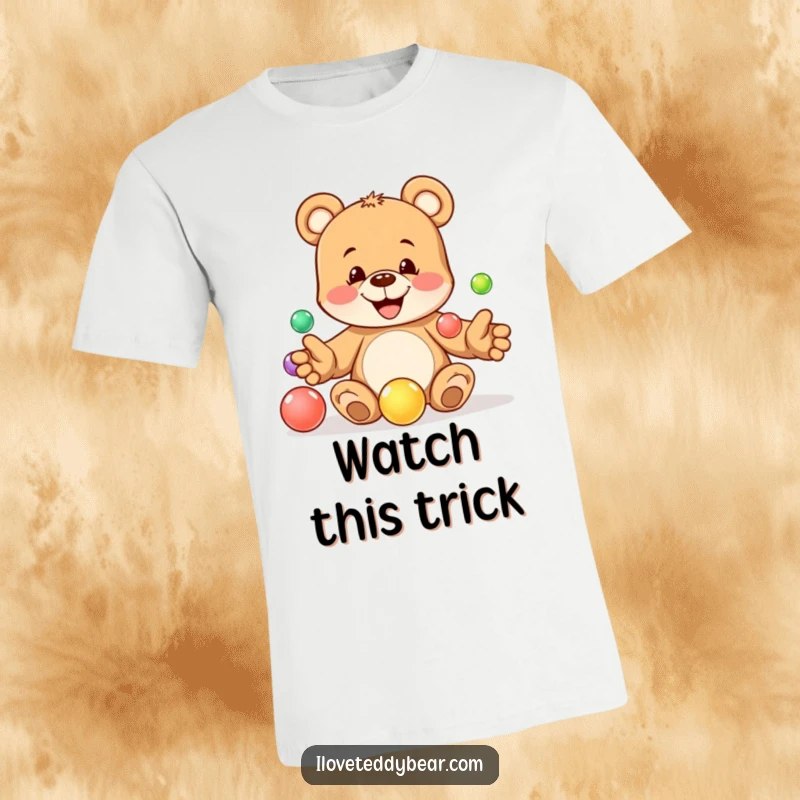 Funny t-shirt showing a playful teddy bear with a mischievous grin attempting to juggle five colorful marbles with skill. A fantastic funny gift.
